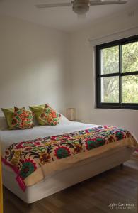 a bedroom with a bed with a colorful blanket on it at Casas del Champaquí in San Javier +60 photos