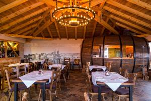 a restaurant with tables and chairs and a chandelier at Motel Konak Mosko in Trebinje