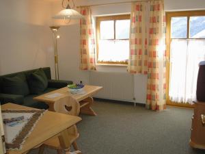 a living room with a couch and a table at Appartement La Piazza in Krimml