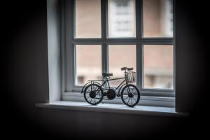 a bike is sitting in a window at Urban Living's - The Huxley in Oxford