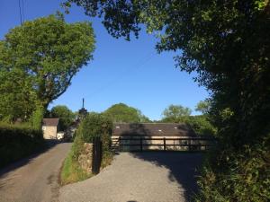 a country road with a bridge and a barn at The Bakery in Llanddeiniol
