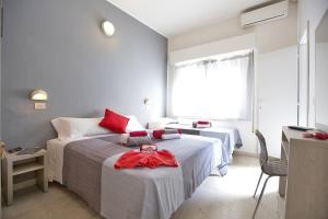 Postel nebo postele na pokoji v ubytování Hotel Sabrina Rimini