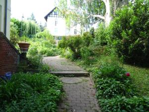 a garden with a stone path in front of a house at Villa Bellevue Dresden in Dresden