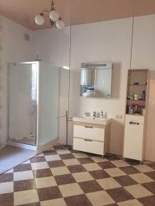 a kitchen with a checkered floor and a refrigerator at Villa u moria Komunstroy 1 in Zatoka