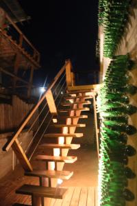 a row of stairs next to a building with lights at Miralejos Complejo de Apartamentos in Punta Del Diablo