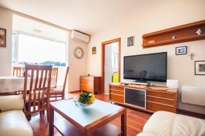 Televízia a/alebo spoločenská miestnosť v ubytovaní La Mia Apartment