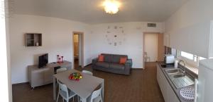 a living room with a table and a couch at Case Vacanza Marzano in Monopoli
