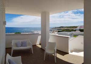 a balcony with chairs and a view of the ocean at Case Vacanza Marzano in Monopoli