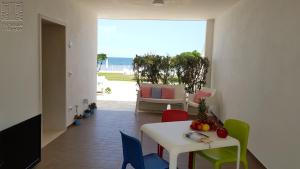 a dining room with a table and chairs and the ocean at Case Vacanza Marzano in Monopoli