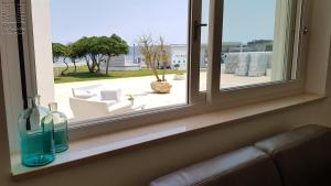 a window with two glass bottles on a ledge at Case Vacanza Marzano in Monopoli