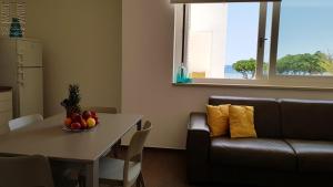 a living room with a table and a couch at Case Vacanza Marzano in Monopoli