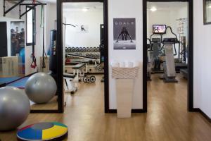a gym with a mirror and some exercise equipment at Starhotels Du Parc in Parma