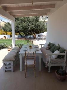 a patio with a couch and a table and chairs at Villa Kedros in Kalamaki Heraklion