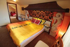 a bedroom with a large bed in a room at Guest House Unika in Tryavna
