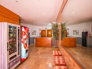 a kitchen with a refrigerator and a counter at Apartaments AR Easy Santa Anna II in Lloret de Mar
