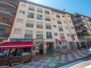a building with a red awning in front of it at Apartaments AR Easy Santa Anna II in Lloret de Mar