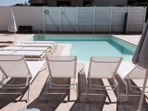 a group of chairs and a swimming pool at Archiammare Sea in San Lorenzo
