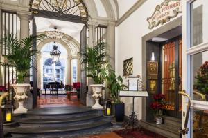 a hallway with a staircase in a building at Relais Santa Croce, By Baglioni Hotels in Florence