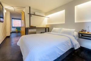 Ένα ή περισσότερα κρεβάτια σε δωμάτιο στο Hotel El Peñon by Bithotels