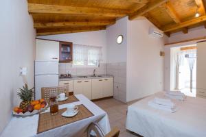 a kitchen with a table and a kitchen with a counter top at Beach apartment M & B in Poljana