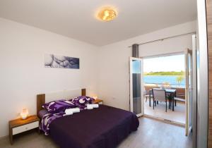 sypialnia z łóżkiem i widokiem na ocean w obiekcie Apartments Clara w Nin