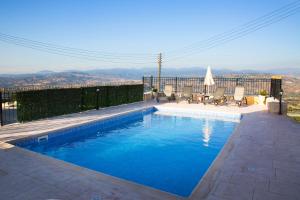 a swimming pool with a view of a city at Valentine's House in Theletra