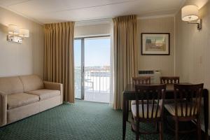 a living room with a couch and a table with chairs at The Spinnaker in Ocean City
