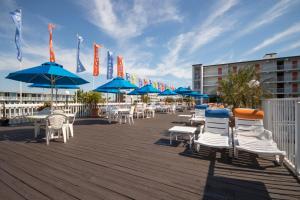 a group of chairs and umbrellas on a boardwalk at The Spinnaker in Ocean City