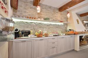 a kitchen with a counter with fruits and vegetables at B&B Issicoro in Baunei
