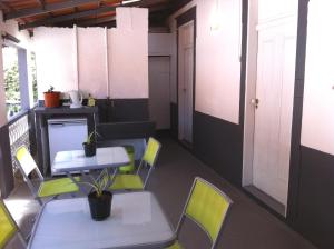 a room with chairs and a table and a table and chairs at Holidays Madeira in São Vicente