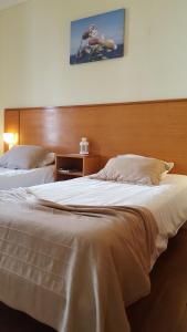 two beds in a hotel room with a large bed at A Casa do Lado in Horta +15 photos