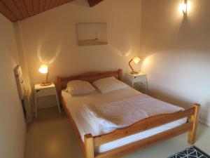 a bedroom with a bed with two lamps on two tables at Les Marines in Biscarrosse-Plage