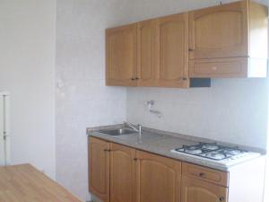 a kitchen with a sink and a stove and cabinets at La Marina Bay in Vieste