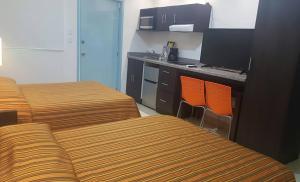 a hotel room with two beds and a desk at Aparthotel Siete 32 in Mérida