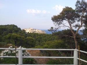 a view of a mountain from a white fence at Hotel Eden in San Domino