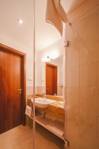 a bathroom with a sink and a shower at Park Hotel Hévíz in Hévíz