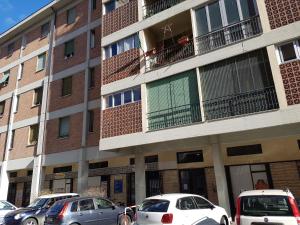a apartment building with cars parked in front of it at FARE BnB - Room & Breakfast Santa Maria in Reggio Emilia
