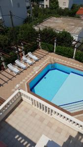 an overhead view of a swimming pool with two lawn chairs at Apartments Romana in Slatine