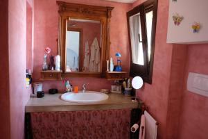 a bathroom with a sink and a mirror at Dammuso Il Sogno in Scauri