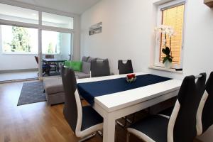 a living room with a table and chairs at Apartma San Simon s pogledom na morje - San Simon Sea View Apartment LL in Izola
