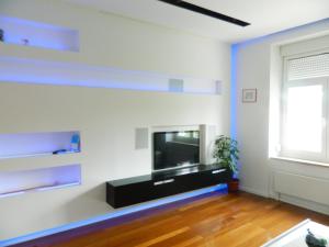 a living room with a flat screen tv on a wall at Apartment light in Pula in Pula