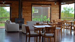 a restaurant with tables and chairs and a fireplace at Cabanas del Bajo Hondo in San Pedro