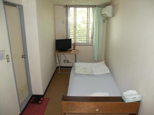 Postel nebo postele na pokoji v ubytování Business Hotel Minshuku Minato