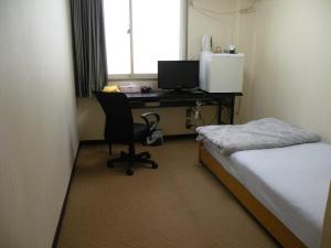 Postel nebo postele na pokoji v ubytování Business Hotel Minshuku Minato