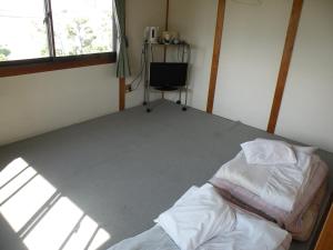 Postel nebo postele na pokoji v ubytování Business Hotel Minshuku Minato