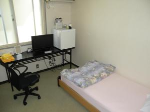 Postel nebo postele na pokoji v ubytování Business Hotel Minshuku Minato