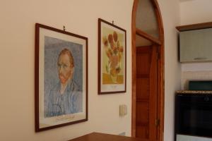 two framed pictures of a man on a wall at Villa Santo Stefano in Monopoli