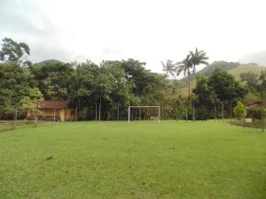 an empty field with a soccer goal at Repousada Sana in Sana
