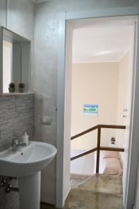 a bathroom with a white sink and a bed at B&B Vistamar in San Nicola Arcella +23 photos