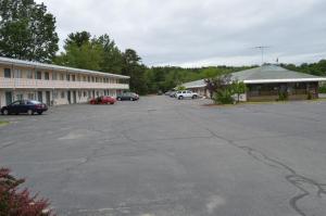 an empty parking lot in front of a building at Nashoba Valley Inn & Suites in Ayer